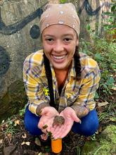 picture of graduate student Briana Davis  holding a frog